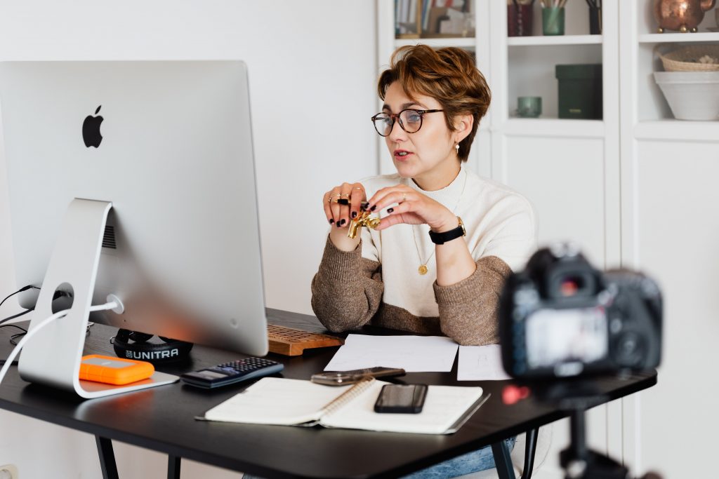 A woman at a computer teaching a course