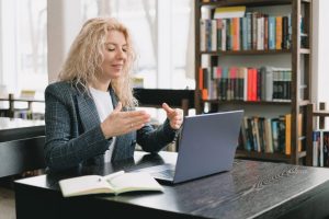 A woman teaching an online course, speaking to her laptop's webcam