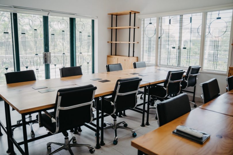 A meeting table surrounded by empty chairs, indicating staff shortages for this association.