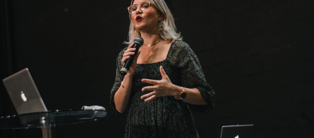 Woman giving a speech on stage