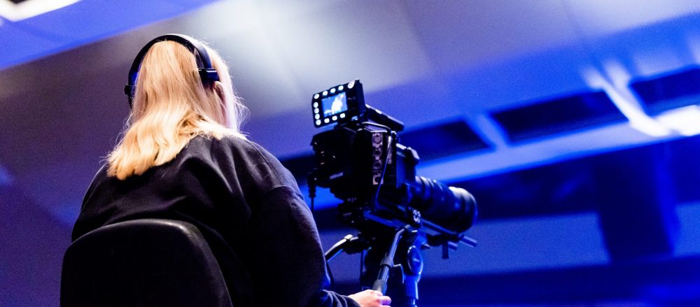 a woman streams an event with a camera