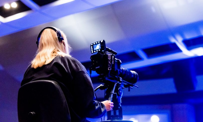 a woman streams an event with a camera