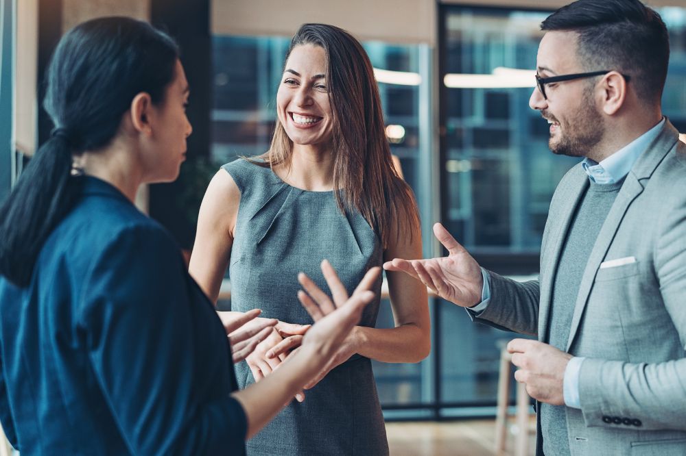 A group of association executives happily chatting at an event.