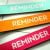 3 colourful strips of paper that say "reminder"