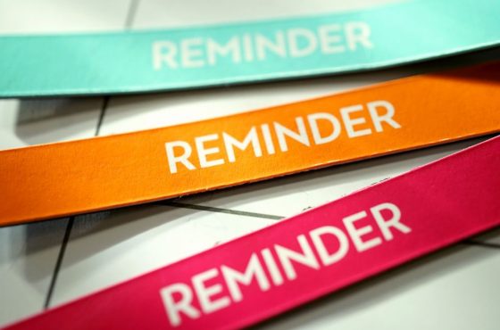 3 colourful strips of paper that say "reminder"