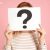 Woman holding a question mark in front of her face