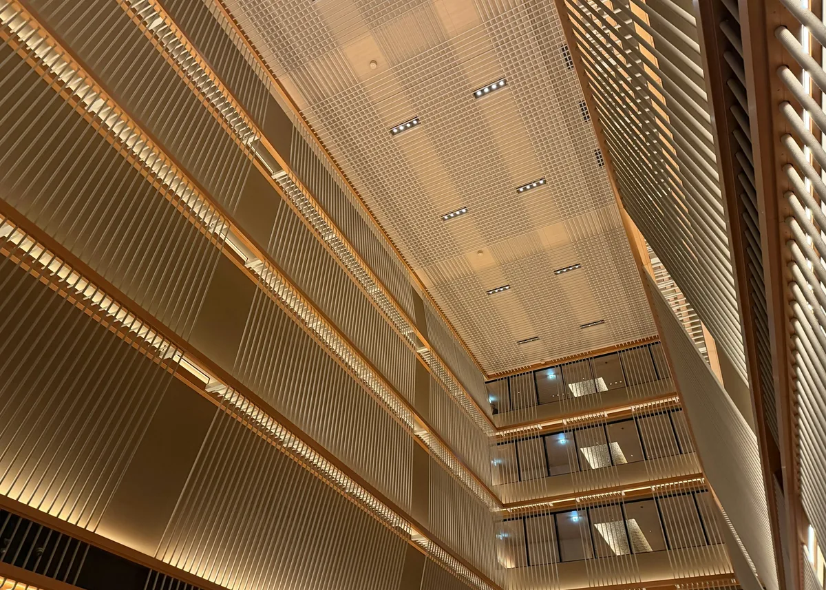 Warm light falls through a geometric interior atrium.