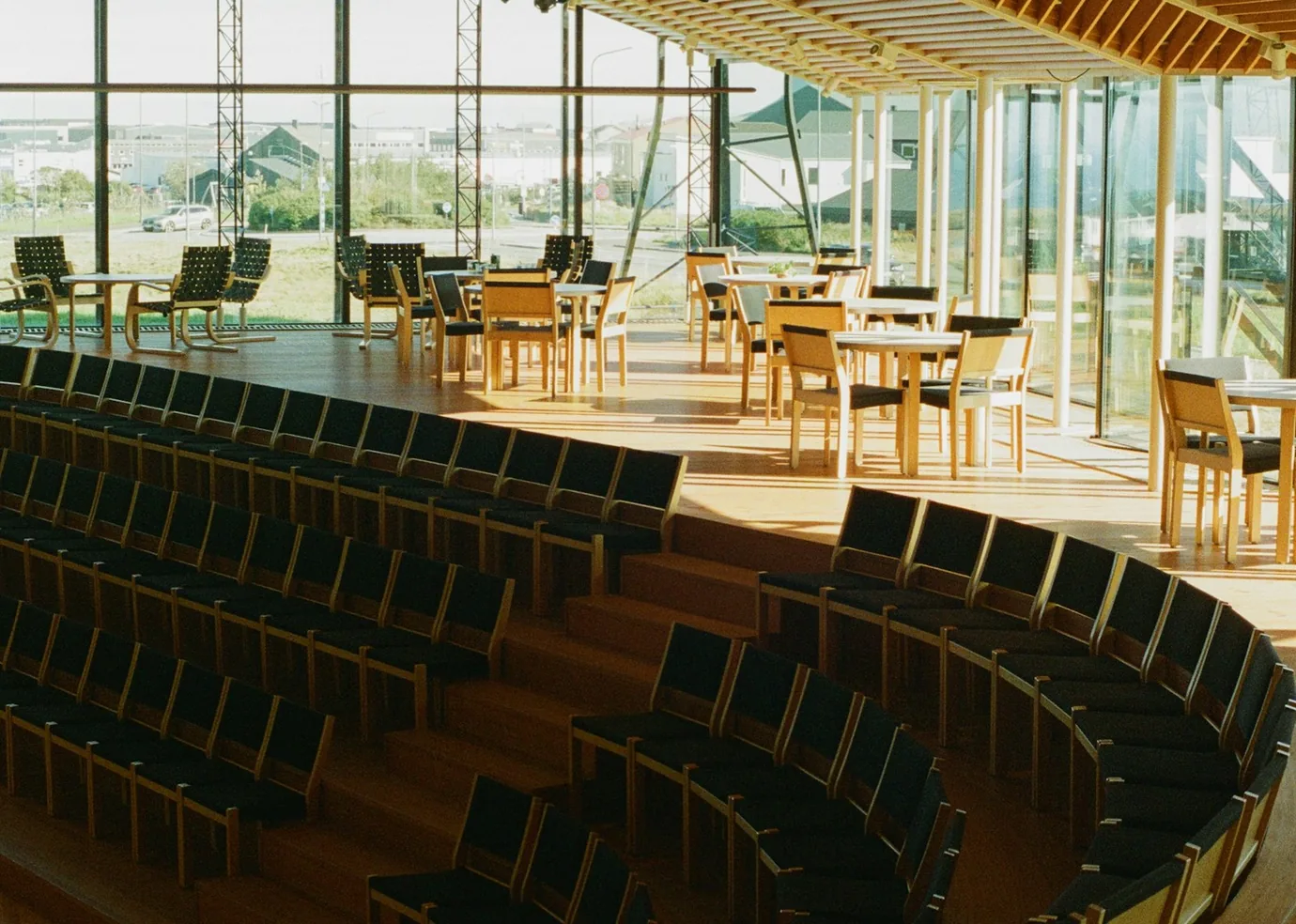 Warm timber conference seating and sunlit windows in a prepared venue.