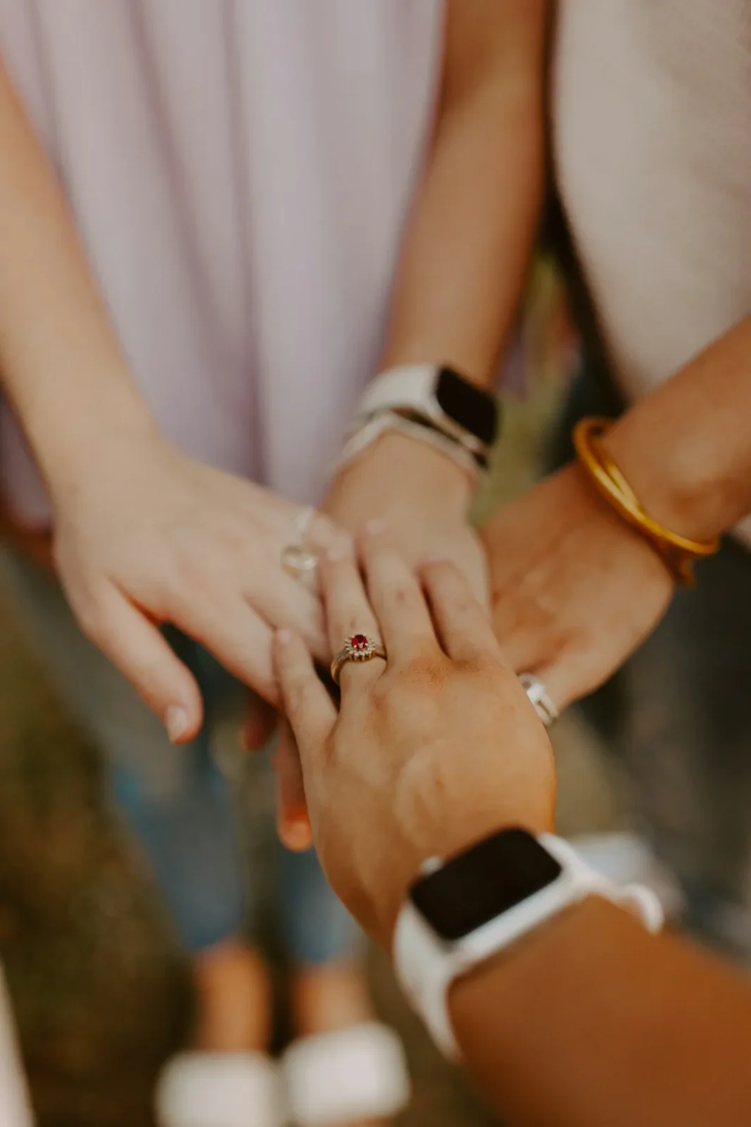 Hands joined together in warm natural light.